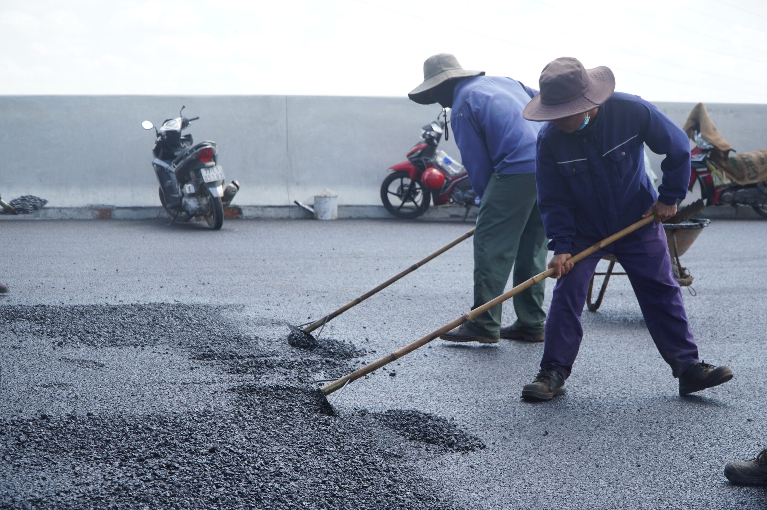 Công nhân hối hả thảm nhựa đường cho kịp tiến độ